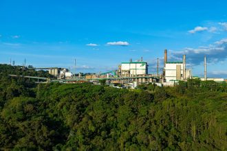 Planta industrial de celulose cercada por uma área de floresta no Brasil